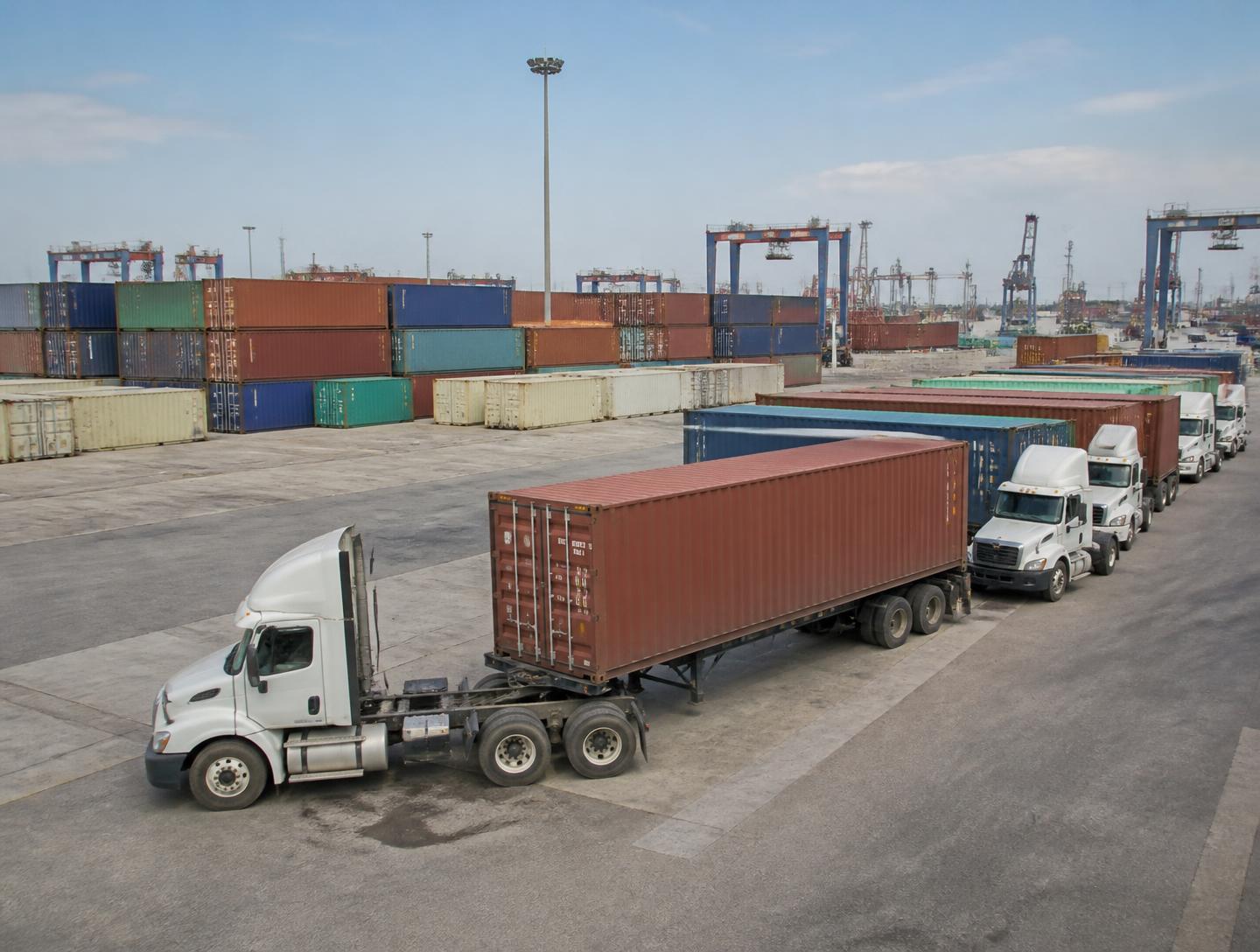 Container yard with drayage trucks staged for pickup